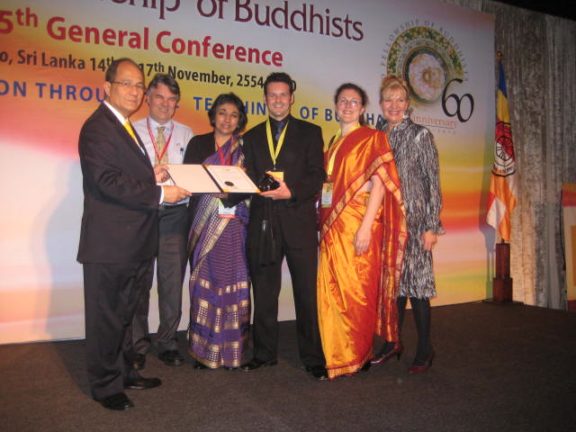 World Fellowship of Buddhist Conference 2010, Buddhist Discussion Centre (Upwey) Ltd. Abbott, Director and Members receiving a certificate and gifts from the Secretary General. Pictured from left to right: Secretary General WFB, Mr Phallop Thaiarry, and Buddhist Discussion Centre (Upwey) Ltd Members: Director Frank Carter, Spiritual Advisor Anita Carter, Simon Kearney, Pennie White and Sally Kelly.